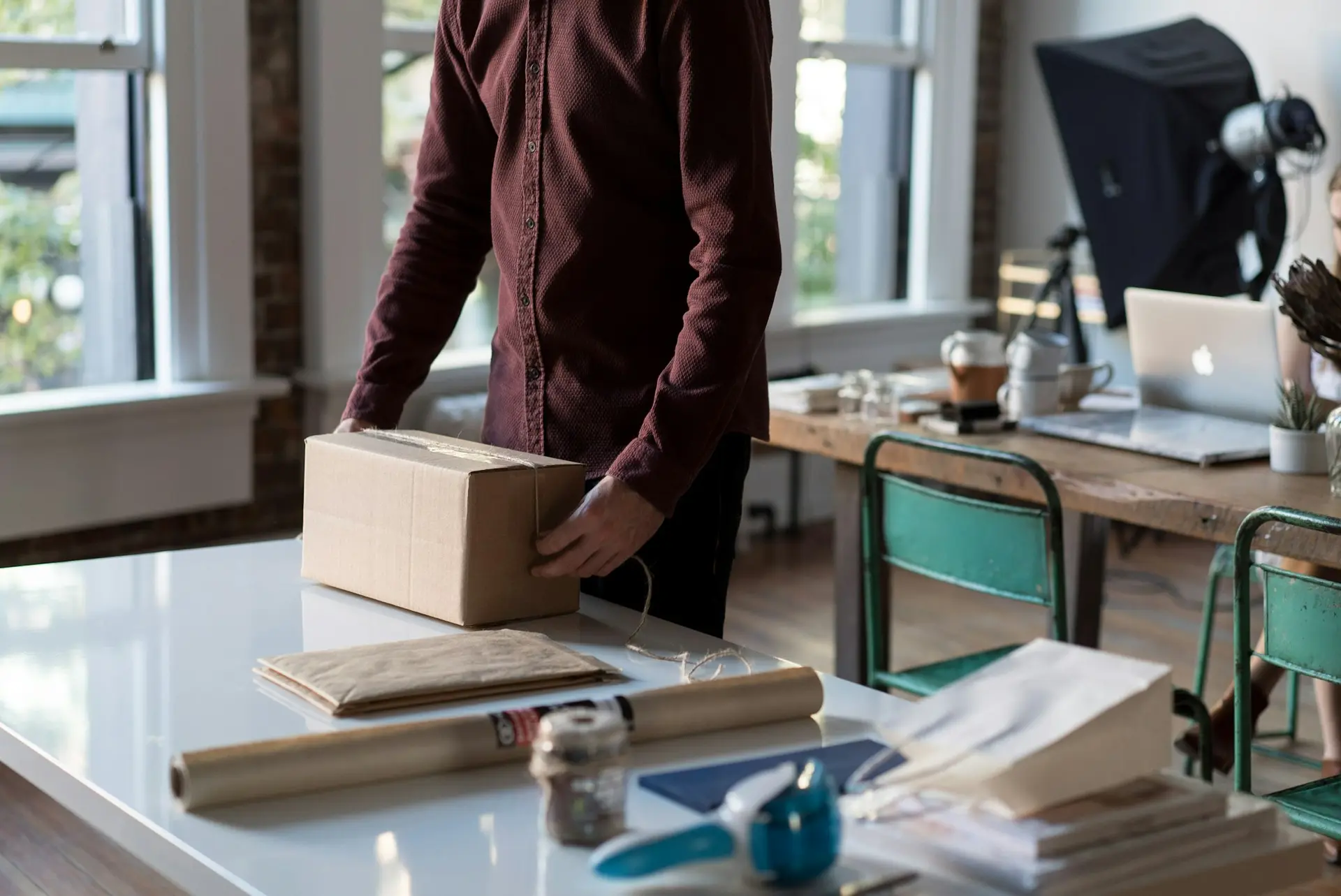 Person holding a box on a table