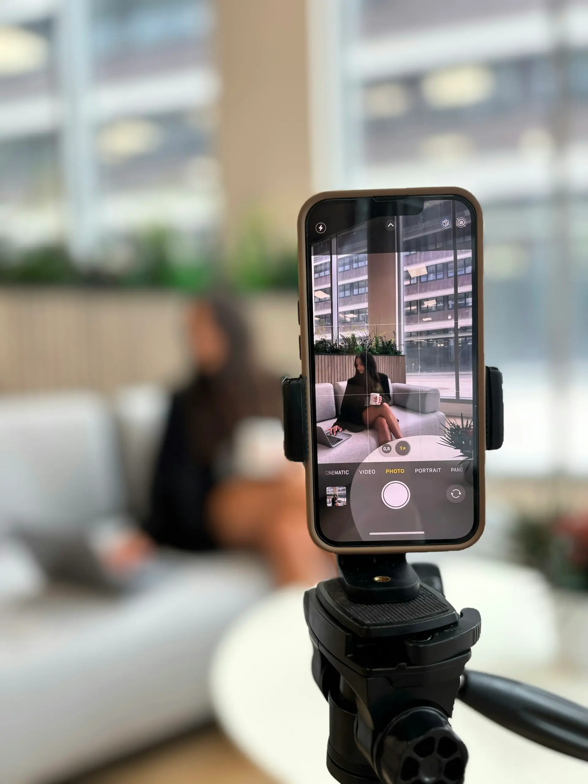 Smartphone recording a woman on a couch