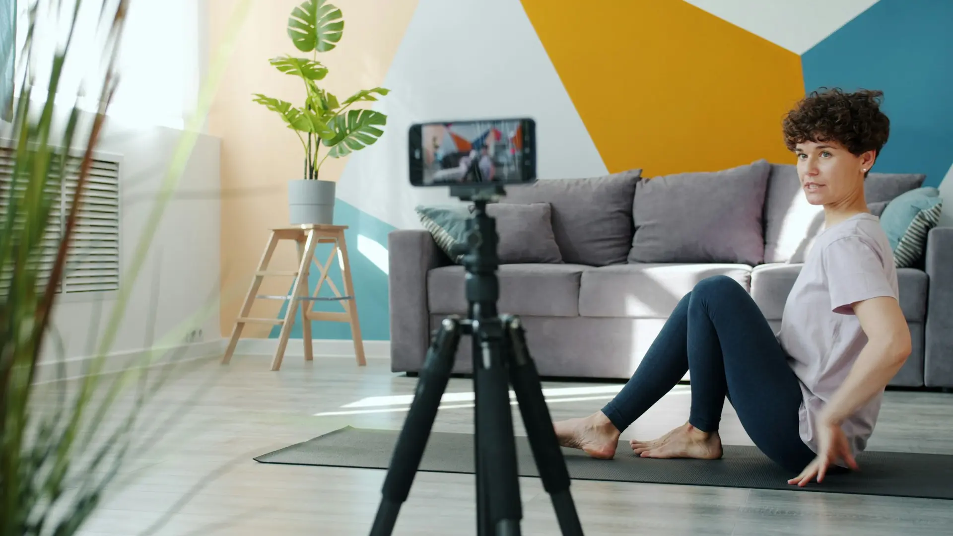 Woman exercising in front of a phone camera