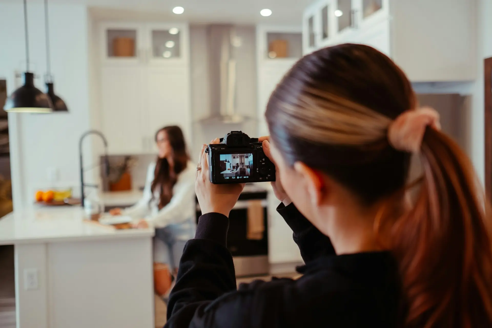 Woman taking a picture of herself in a kitchen