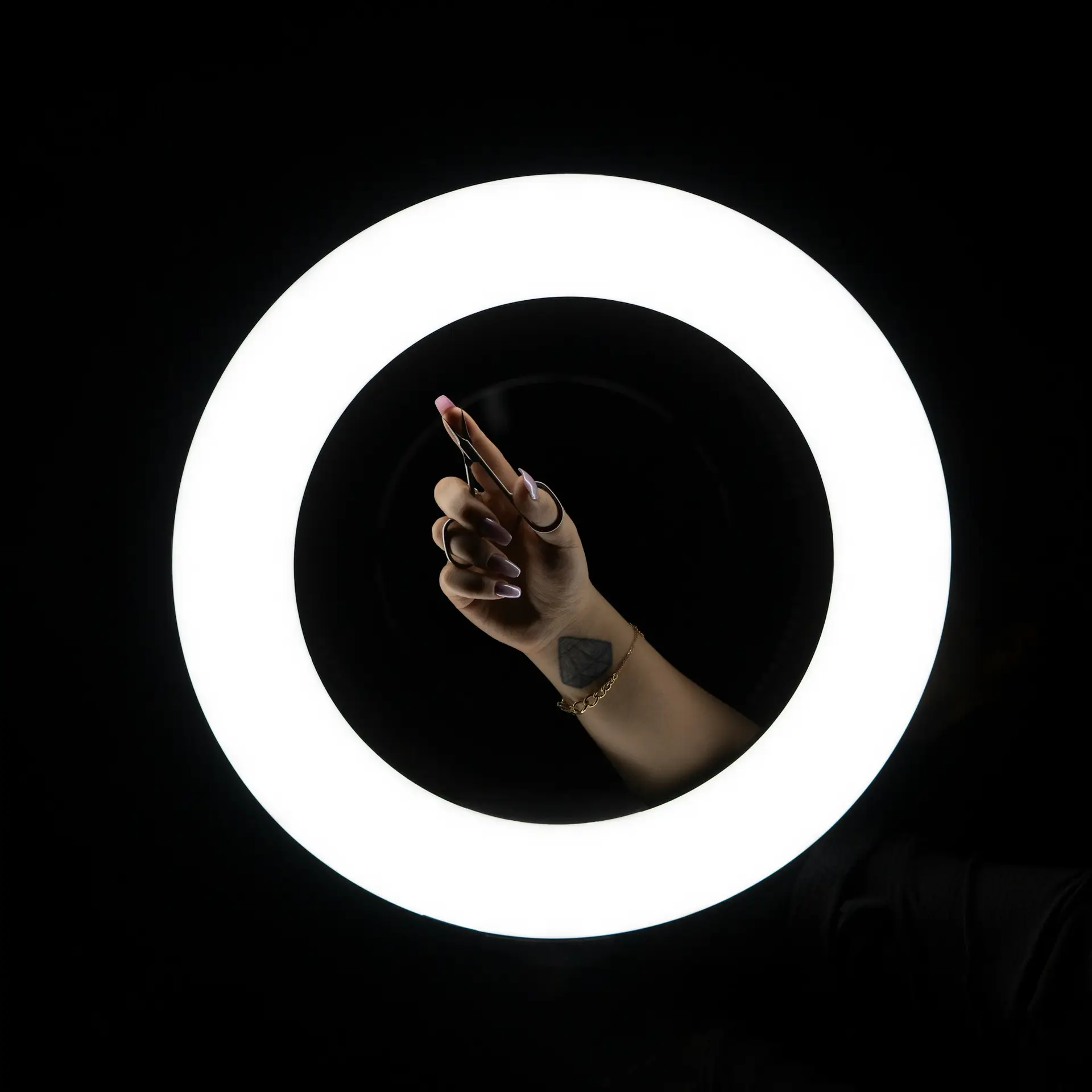 Phone held in front of a circular light