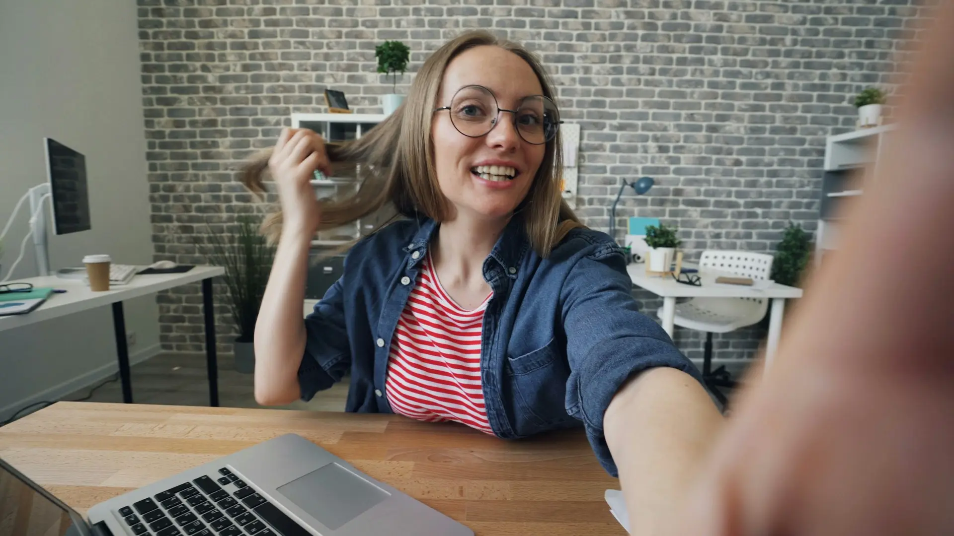 Woman sitting at a table in front of a laptop