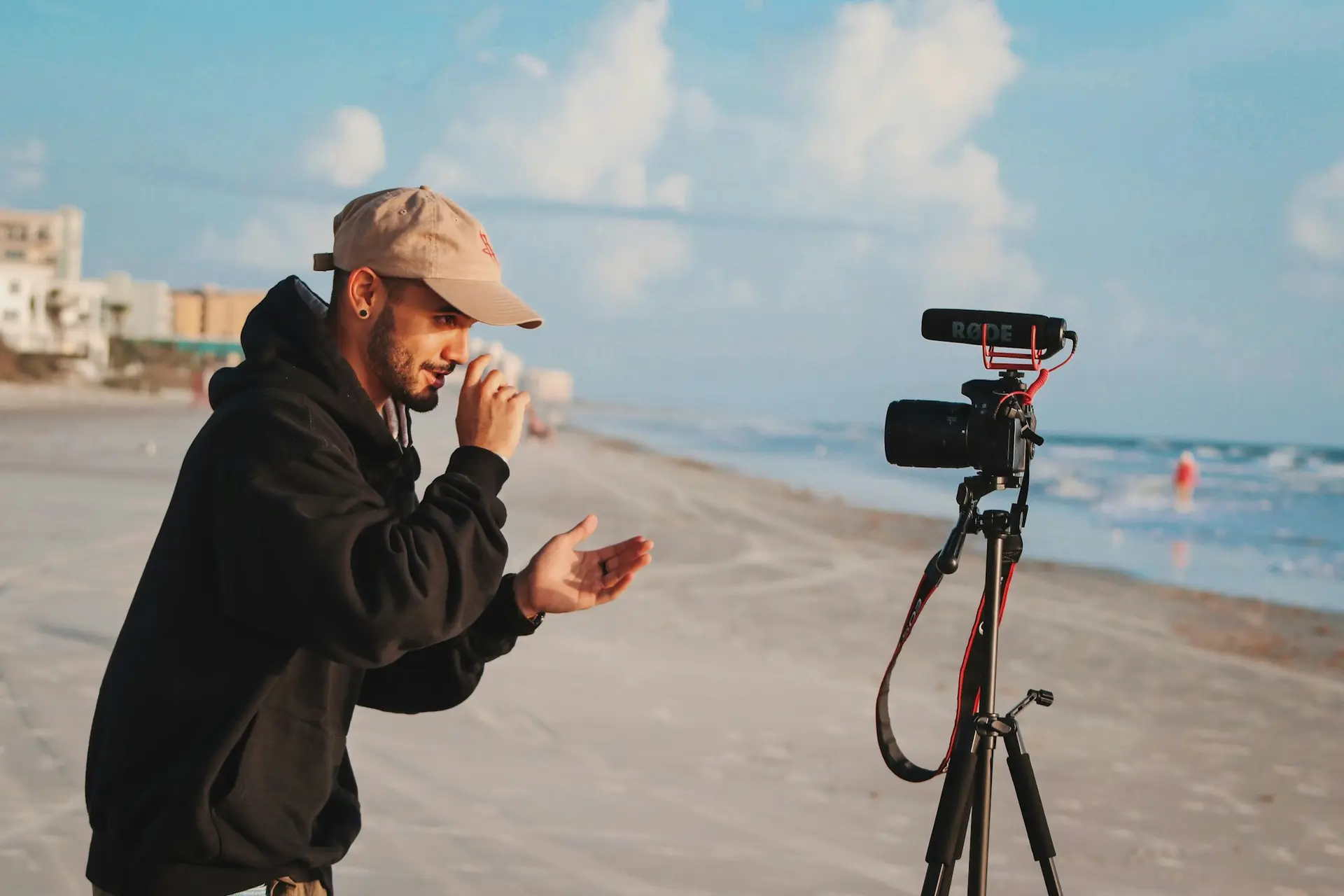 Man in a black jacket holding a camera