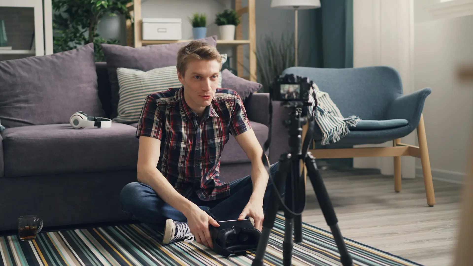 Man sitting on the floor in front of a camera
