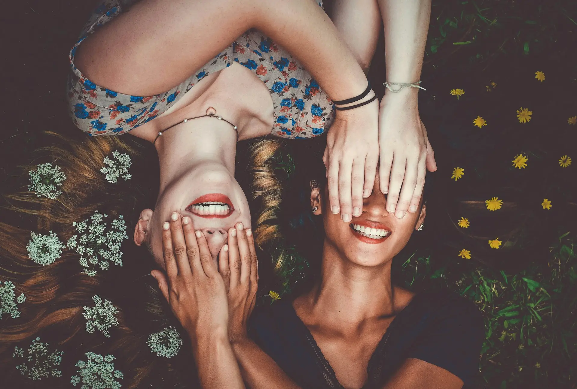Man and woman smiling on a lawn
